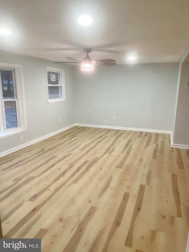 spare room featuring ceiling fan and light hardwood / wood-style floors