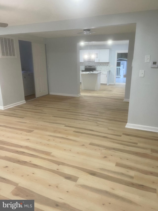 unfurnished living room with light hardwood / wood-style flooring