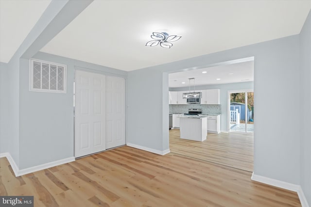 1356 College Rd, Dover, DE 19904 - unfurnished living room featuring baseboards, light wood-type flooring, and recessed lighting