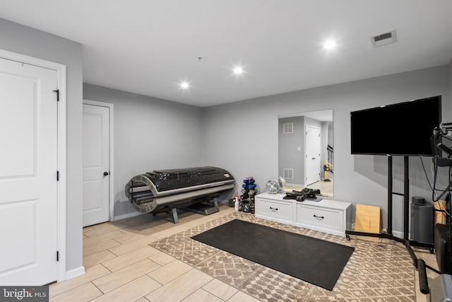 exercise room featuring light hardwood / wood-style floors