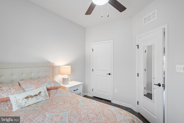 bedroom featuring dark hardwood / wood-style floors and ceiling fan