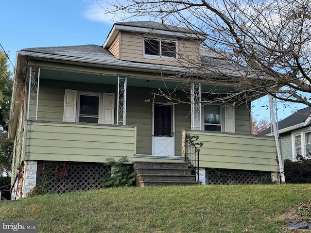 bungalow-style house with a front lawn