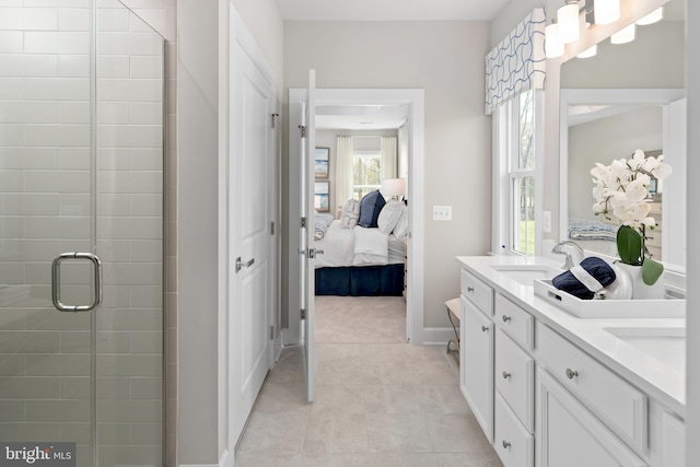 bathroom with vanity, tile patterned floors, and a shower with door