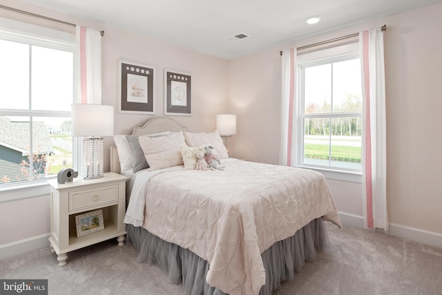 carpeted bedroom with multiple windows