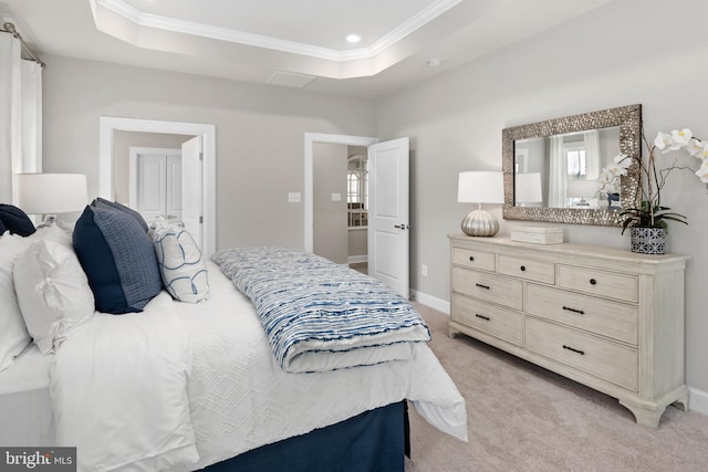 bedroom featuring light colored carpet, a raised ceiling, and crown molding