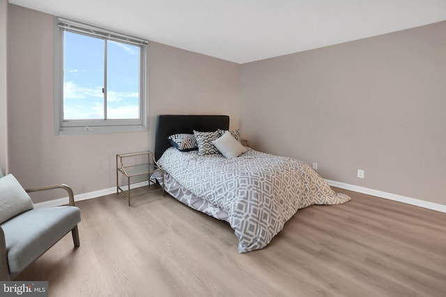 bedroom with hardwood / wood-style floors