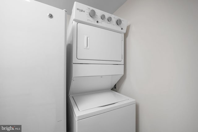 laundry area with stacked washer / dryer