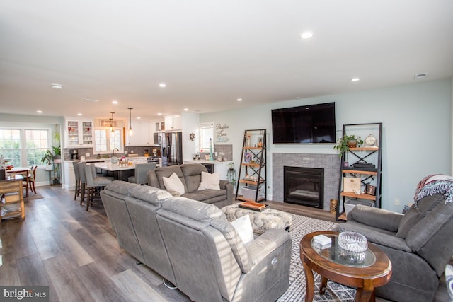 living room with sink and light hardwood / wood-style floors