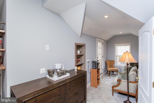 sitting room featuring light colored carpet and vaulted ceiling