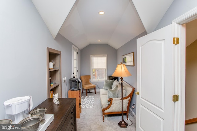 living area featuring carpet and vaulted ceiling