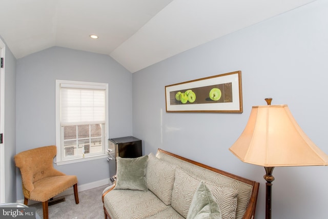 living area with carpet flooring and lofted ceiling