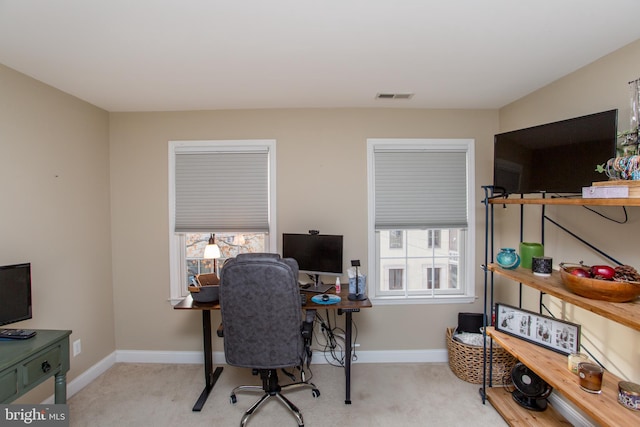 office area featuring light carpet