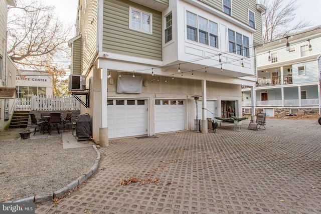 rear view of property with a garage