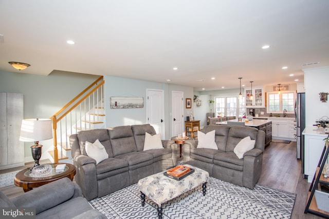 living room with sink and dark wood-type flooring