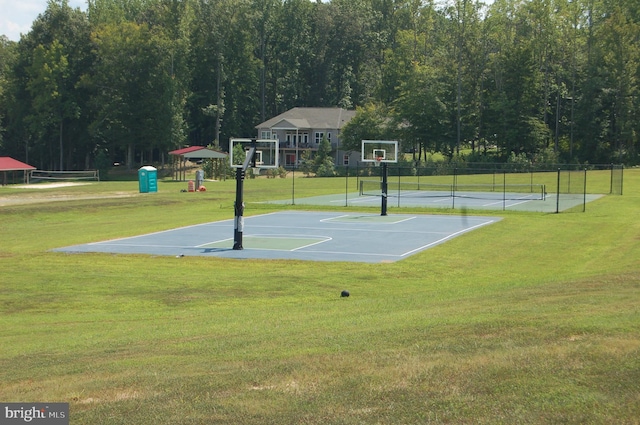 view of sport court featuring a tennis court, community basketball court, fence, and a yard