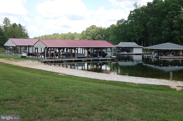 dock area featuring a water view, a yard, and boat lift