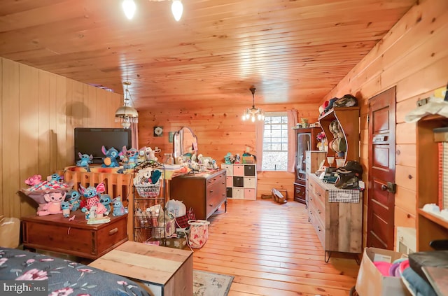 miscellaneous room featuring wood ceiling, light wood-type flooring, and wooden walls