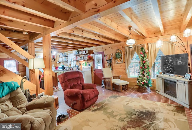 living room featuring beamed ceiling, washer / dryer, and wooden ceiling