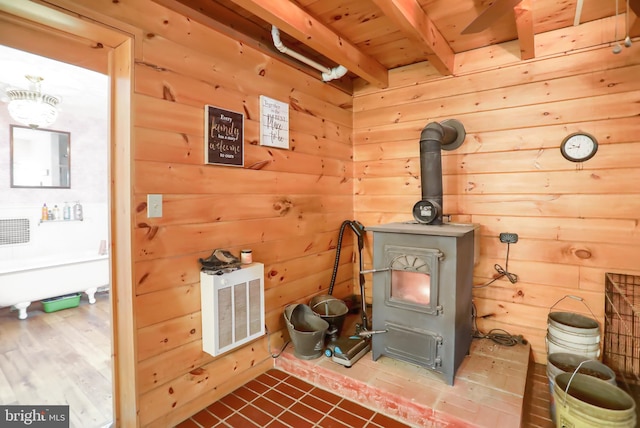 room details featuring a wood stove and wooden walls