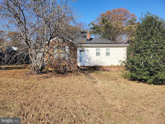 view of side of property with a lawn