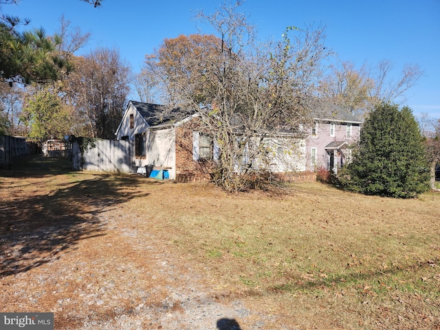 view of side of property with a yard