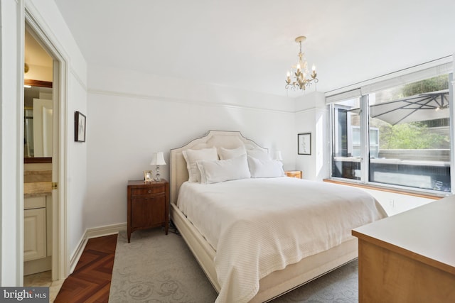 bedroom with dark parquet floors and a chandelier