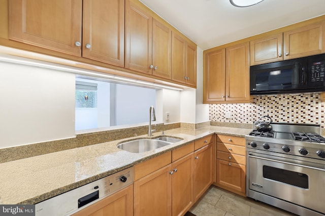 kitchen featuring luxury range, sink, decorative backsplash, light stone countertops, and light tile patterned flooring