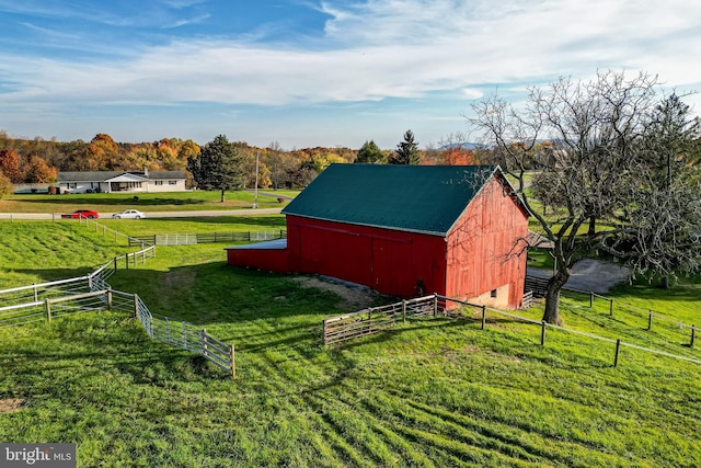 view of outbuilding featuring a yard and a rural view