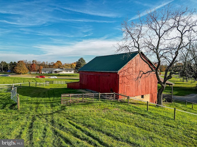 view of outdoor structure featuring a lawn and a rural view