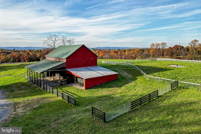 surrounding community featuring a rural view and an outdoor structure