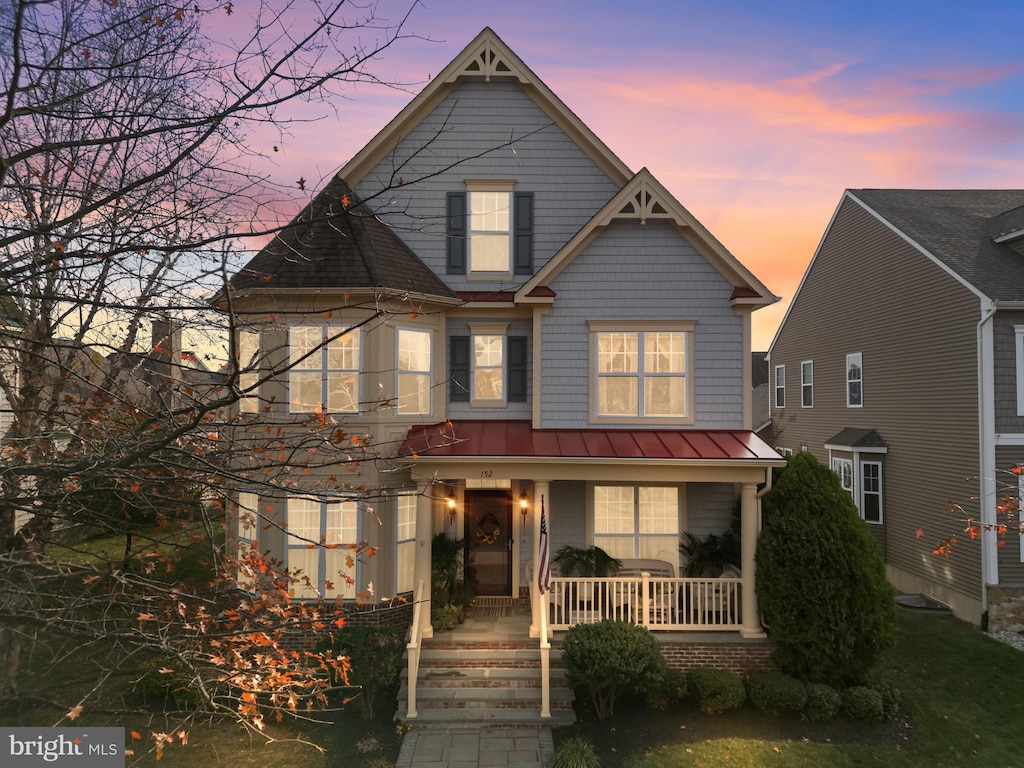 152 Tuscany Dr, Middletown, DE 19709 - view of front of home featuring covered porch, a standing seam roof, and metal roof