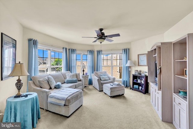 carpeted living room with ceiling fan