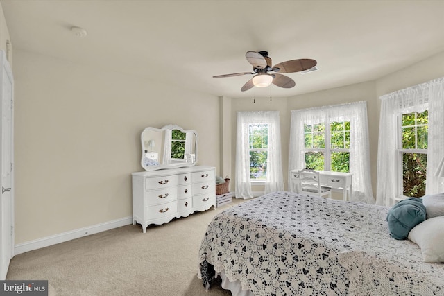 bedroom with ceiling fan and light carpet