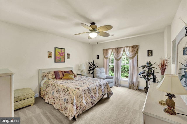 bedroom with ceiling fan and light carpet