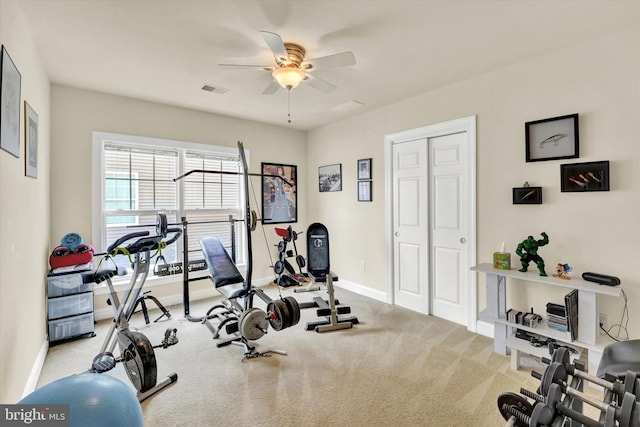 workout area with ceiling fan and light colored carpet