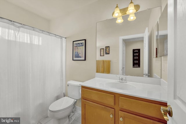 bathroom with toilet, vanity, and tile patterned flooring