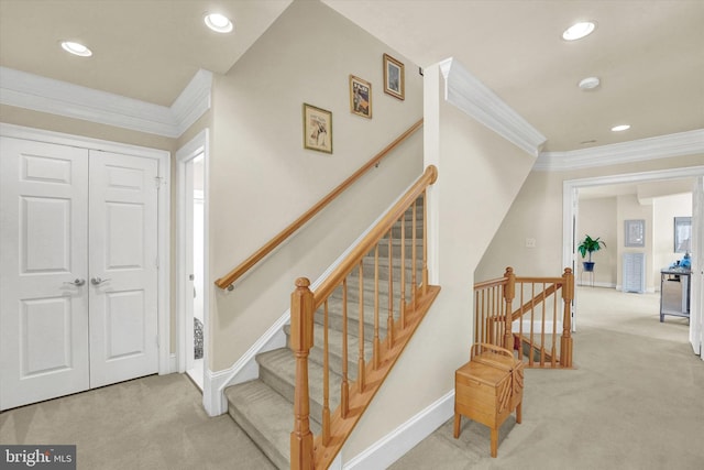 staircase with ornamental molding and carpet flooring