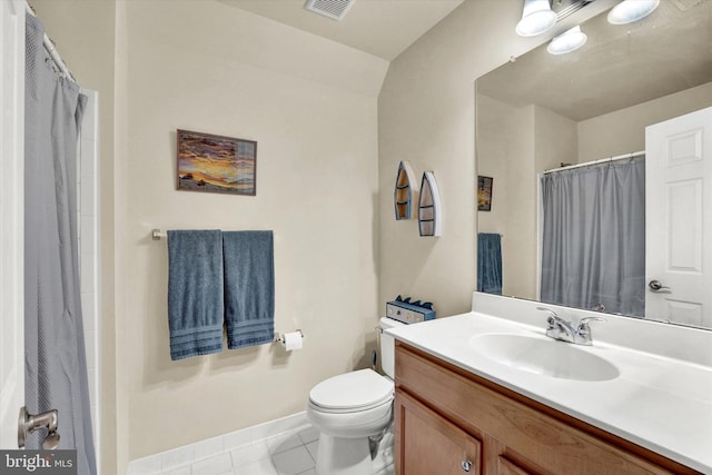 bathroom with toilet, tile patterned floors, and vanity