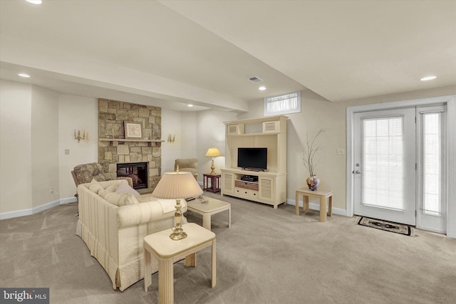 carpeted living room with a fireplace