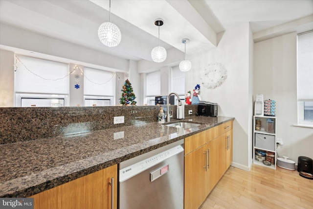 kitchen with dark stone counters, sink, pendant lighting, light hardwood / wood-style flooring, and dishwasher