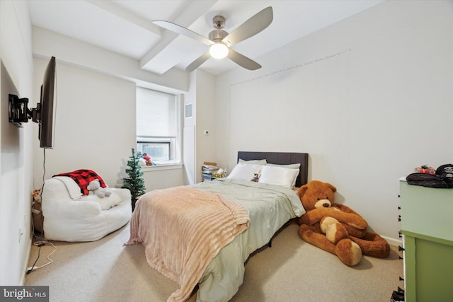 bedroom with ceiling fan, beamed ceiling, and carpet