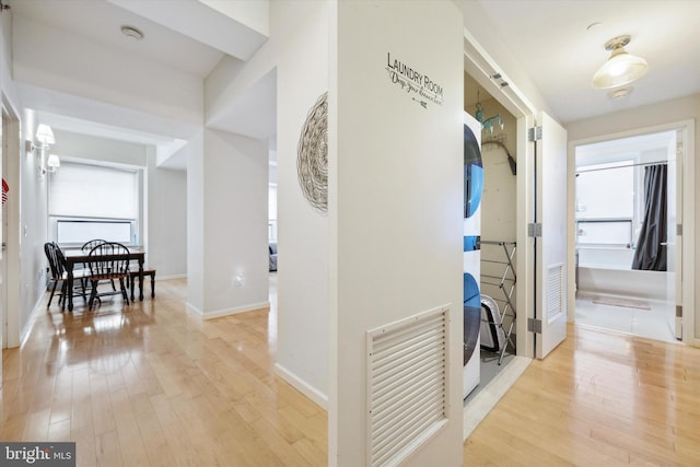 hall featuring plenty of natural light and light hardwood / wood-style flooring