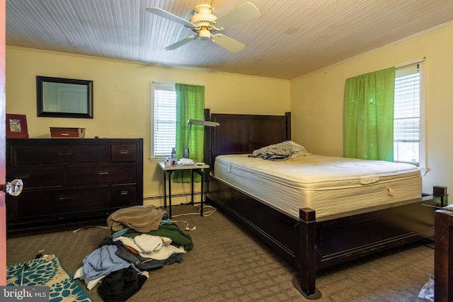 bedroom featuring ceiling fan, a baseboard heating unit, and ornamental molding