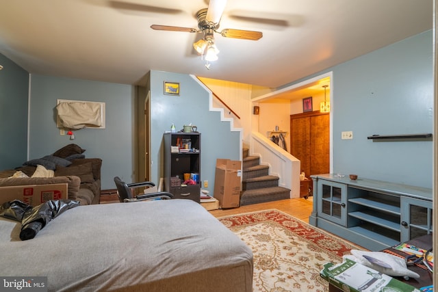 bedroom with ceiling fan and light hardwood / wood-style floors