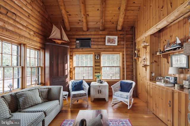 interior space with vaulted ceiling with beams, light wood-type flooring, and plenty of natural light