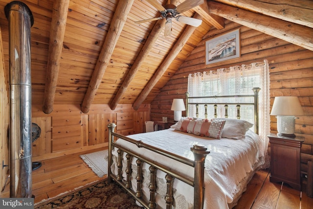 bedroom featuring dark hardwood / wood-style flooring, lofted ceiling with beams, ceiling fan, and wood ceiling