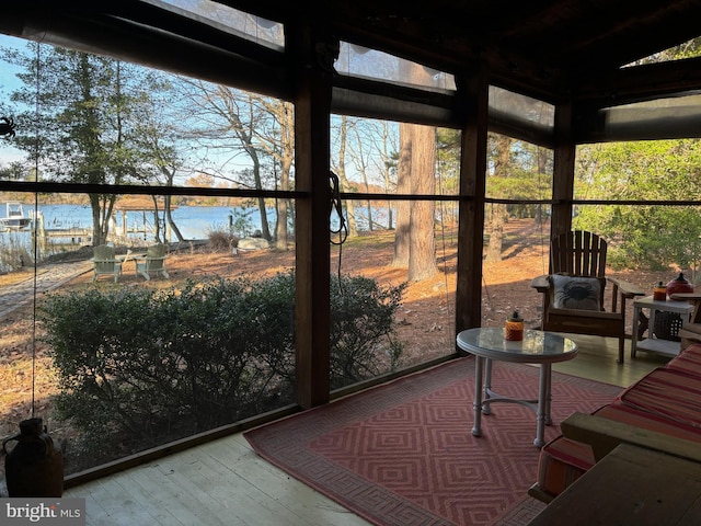 unfurnished sunroom with a water view and a healthy amount of sunlight