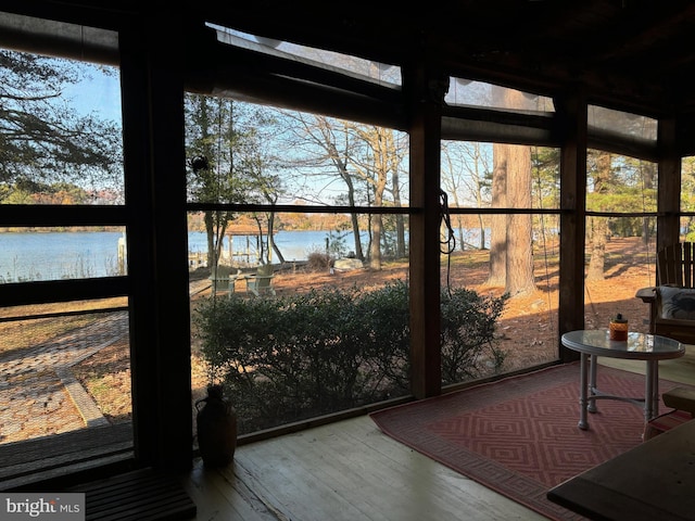 sunroom / solarium featuring a healthy amount of sunlight and a water view