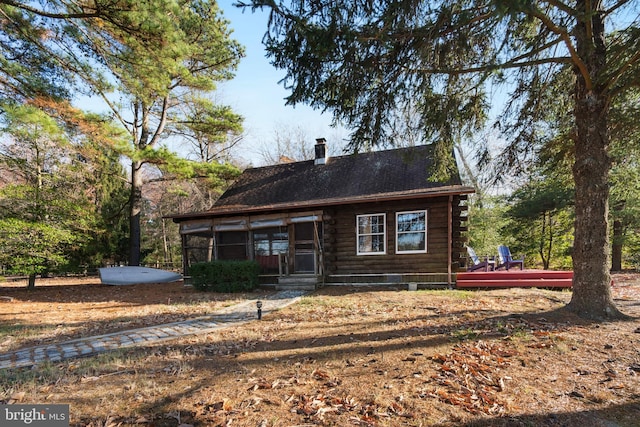 log-style house featuring a wooden deck