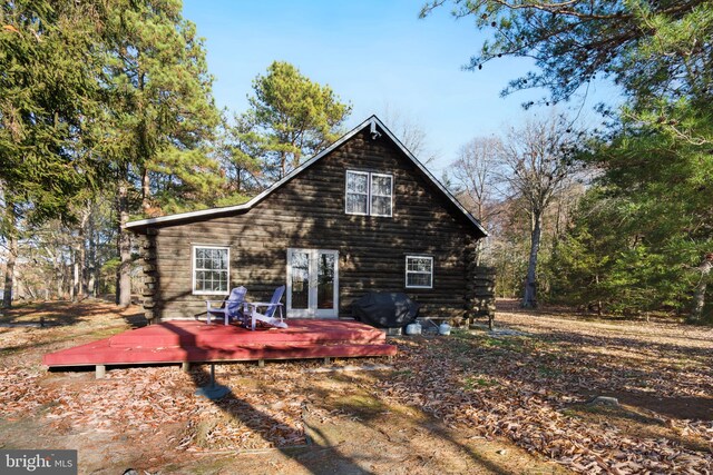 rear view of house featuring a wooden deck